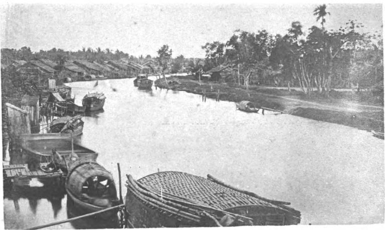 The port of Rạch Giá, showing the French colonial building and wooden docks along the waterfront